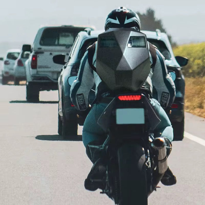 Motorcyclist on a highway with cars in the background