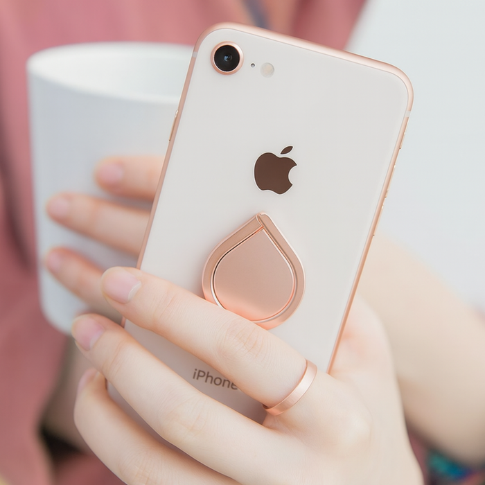 Rose gold phone case with teardrop design on an iPhone held by a person.