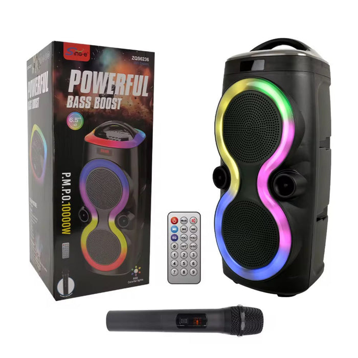 Portable speaker with colorful LED lights, remote control, and microphone on a white background