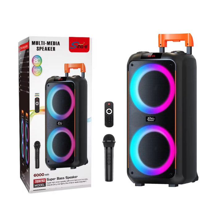 Portable speaker with RGB lighting, remote control, and microphone next to its packaging on a white background.