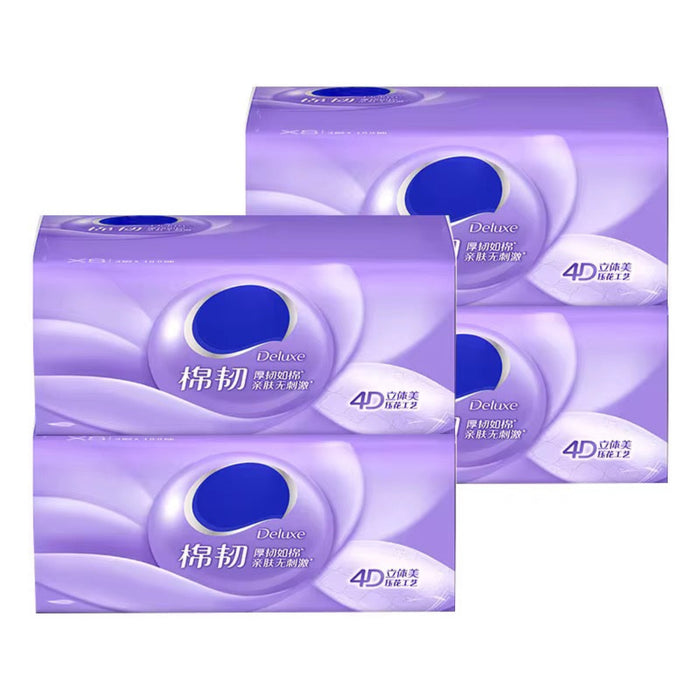 Three boxes of Deluxe toilet paper with a purple and white design on a white background