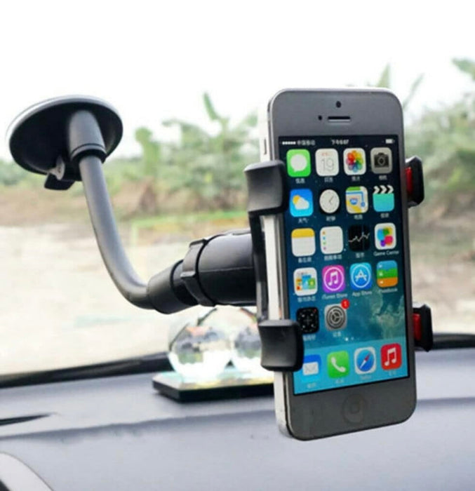 Phone holder with a smartphone displaying app icons on a car dashboard.