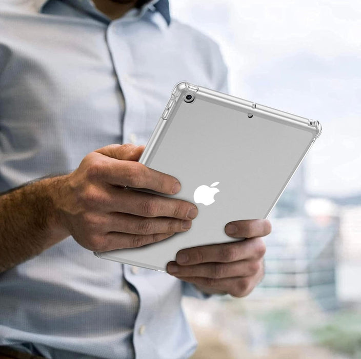 Person holding a white Apple iPad with a clear case.