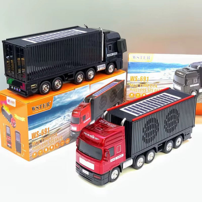 Toy truck with a trailer on top of its packaging box, with another truck in the background.