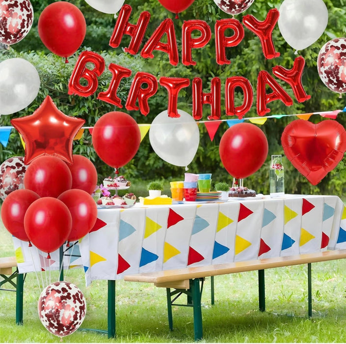 Birthday party setup with balloons and table decorations outdoors