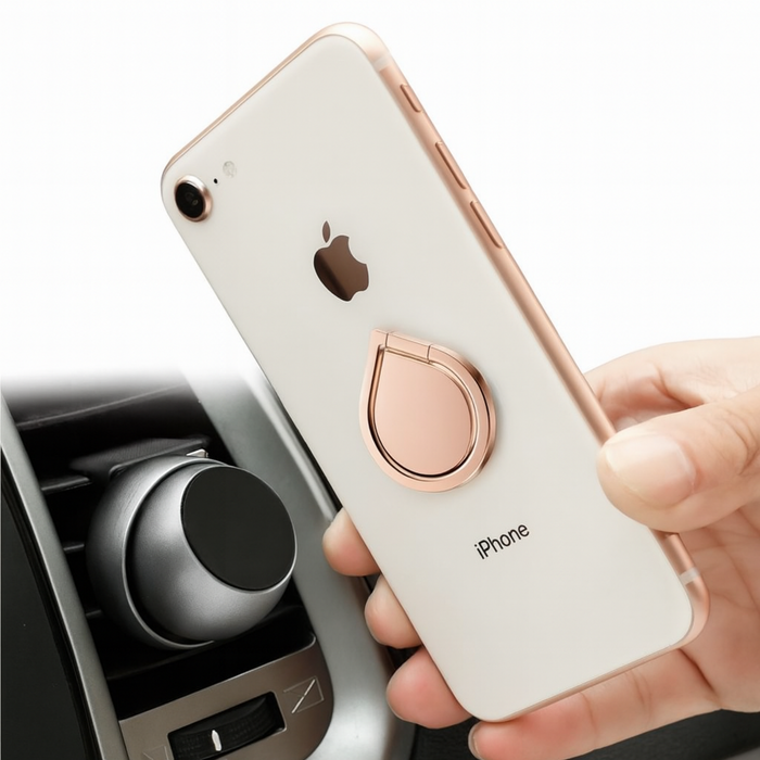 Hand holding a white iPhone with a rose gold ring holder, car air vent in background