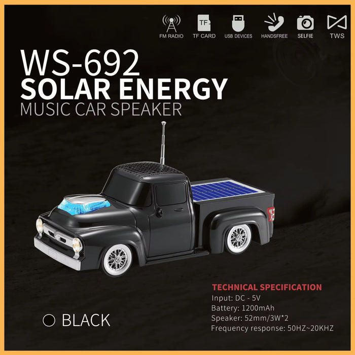 Black toy truck-shaped solar energy music speaker with features listed on a dark background