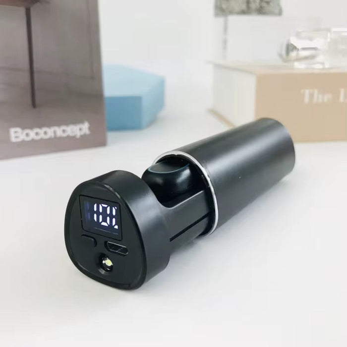 Black electronic device with digital display on a white surface, Boconcept brand visible in the background.