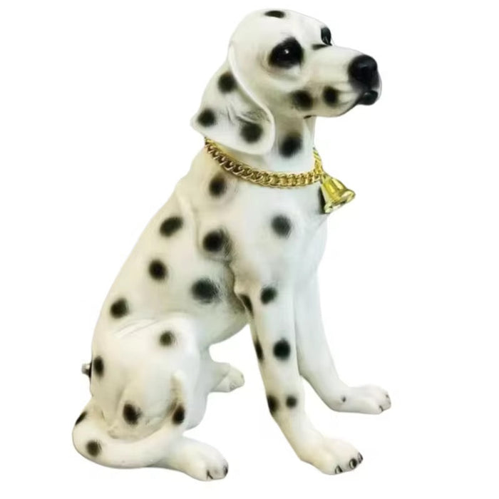 Decorative figurine of a Dalmatian dog with a gold chain collar on a white background