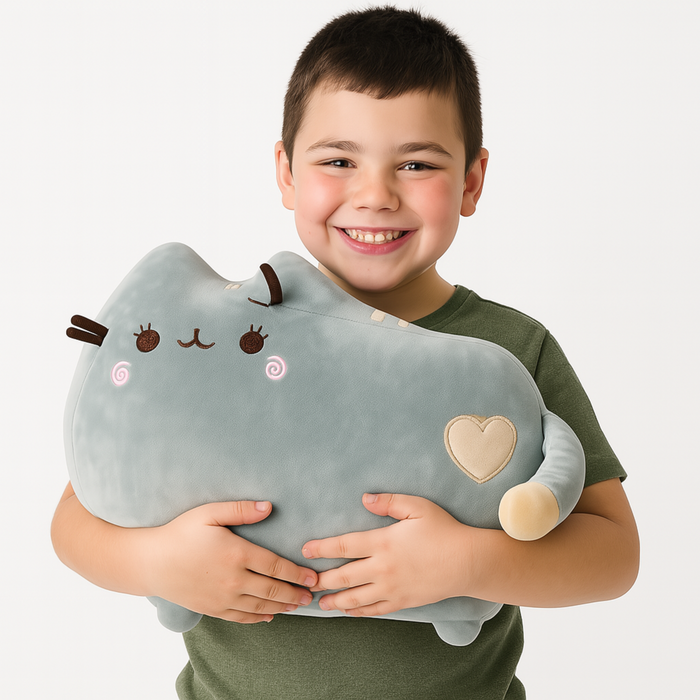 Child holding a plush toy with a heart and smiling