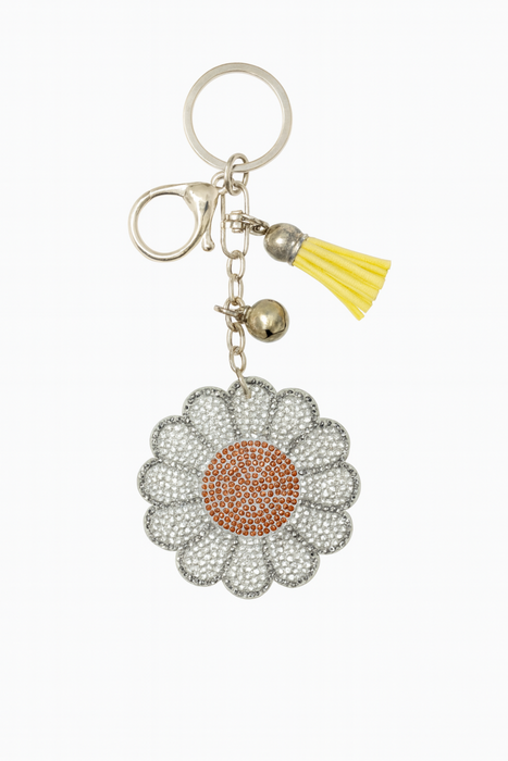 Keychain with a daisy flower charm and tassel on a white background