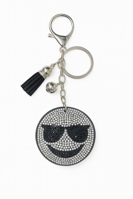 Keychain with smiley face design and tassel on a white background