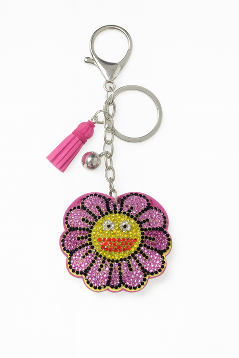 Keychain with a colorful flower charm and tassel on a white background