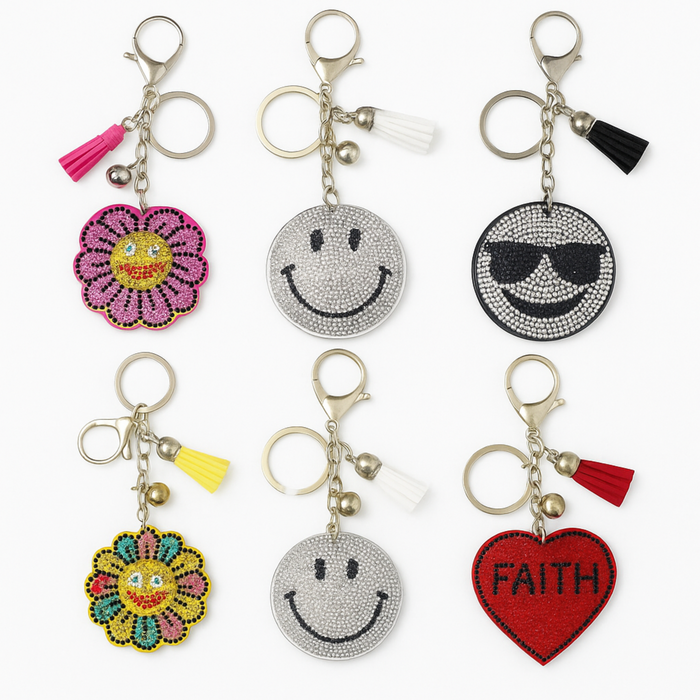 Set of colorful keychains with smiley faces, flowers, and 'FAITH' heart on a white background