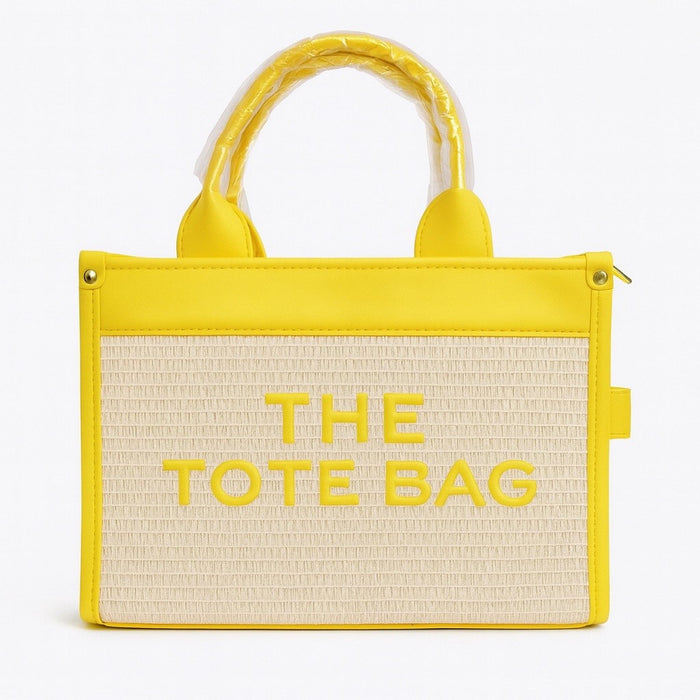Yellow and beige tote bag with 'THE TOTE BAG' text on a white background