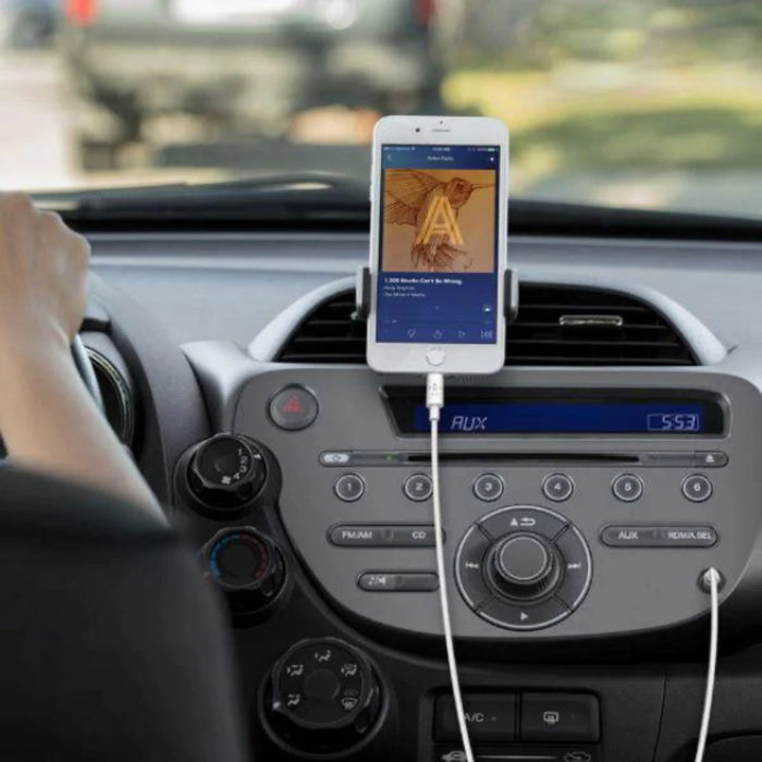 Phone mounted on a car dashboard with a charging cable, displaying an app.