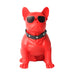 Red dog-shaped object with sunglasses and a collar on a white background