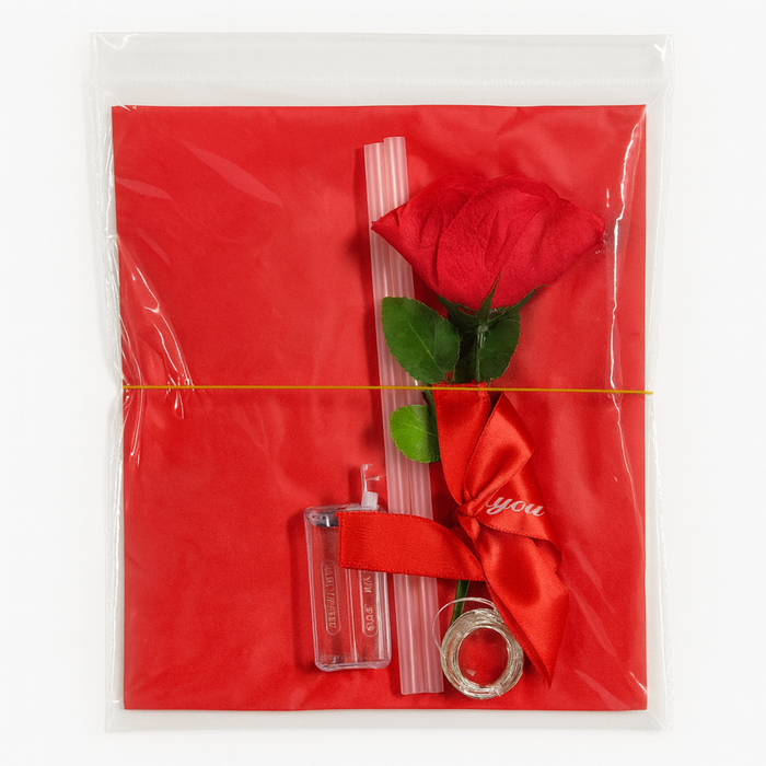 Red rose with a clear box and ring on a red card inside clear packaging