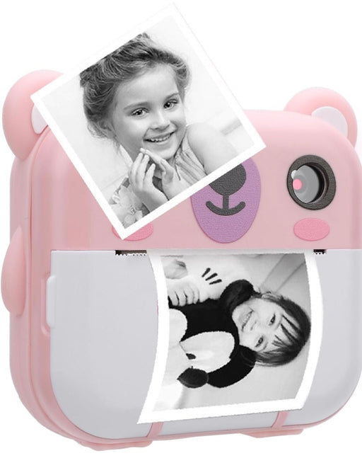 Pink toy camera with printed photos on a white background