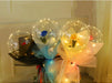 Bouquets of flowers in transparent balloons with LED lights on a white surface.