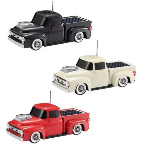 Three toy trucks in black, white, and red on a white background