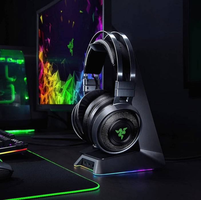 Gaming headset on a stand with colorful computer screens in the background