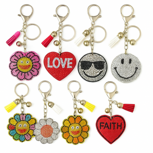 Collection of colorful keychains with various designs on a white background