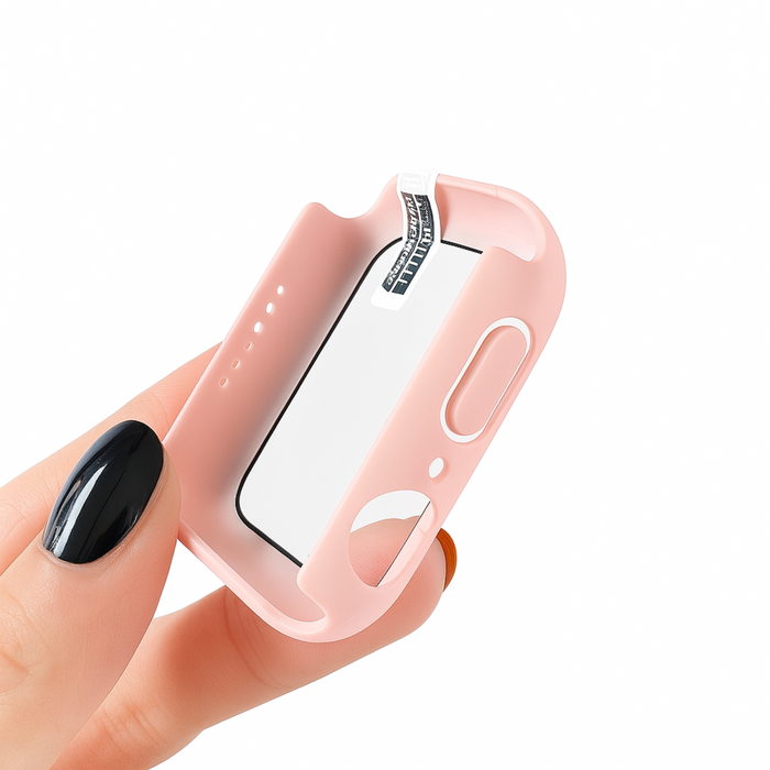 Pink smartwatch case held by a hand with black nail polish on a white background