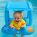 Child in a blue inflatable pool seat with ocean-themed decorations in a pool.