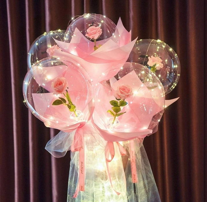 Bouquet of balloons with pink ribbons and flowers against a brown curtain background