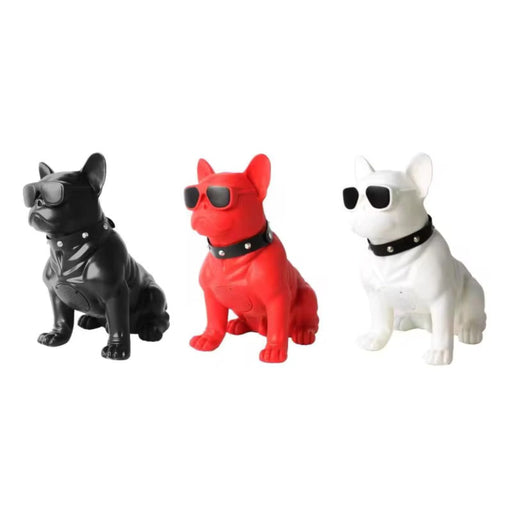 Three dog figurines in black, red, and white with sunglasses on a white background