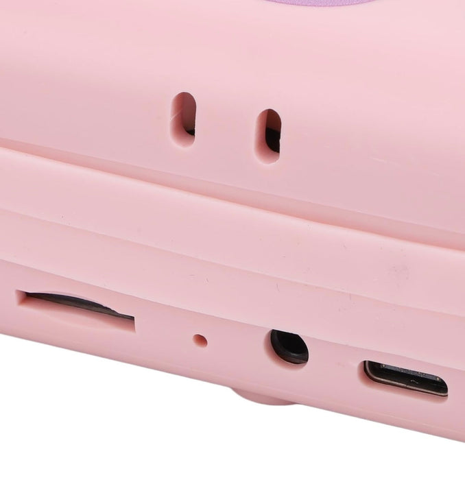Close-up of a pink electronic device with ports and buttons on a white background