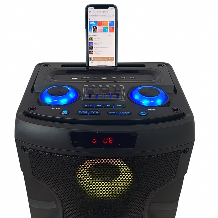 Black portable speaker with blue lights and a smartphone on top displaying music app interface.