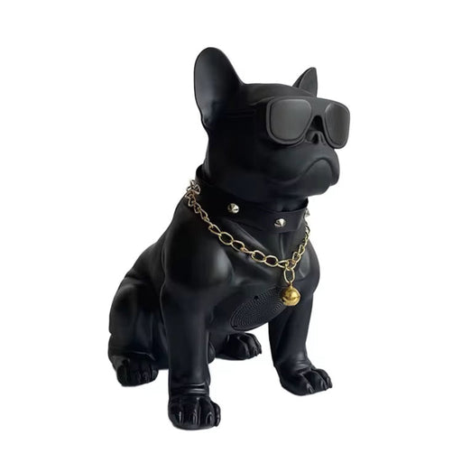 Black dog figurine with sunglasses and a gold chain on a white background
