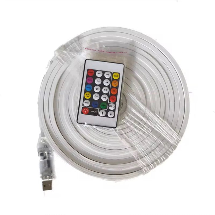 Roll of LED strip light with remote control on a white background