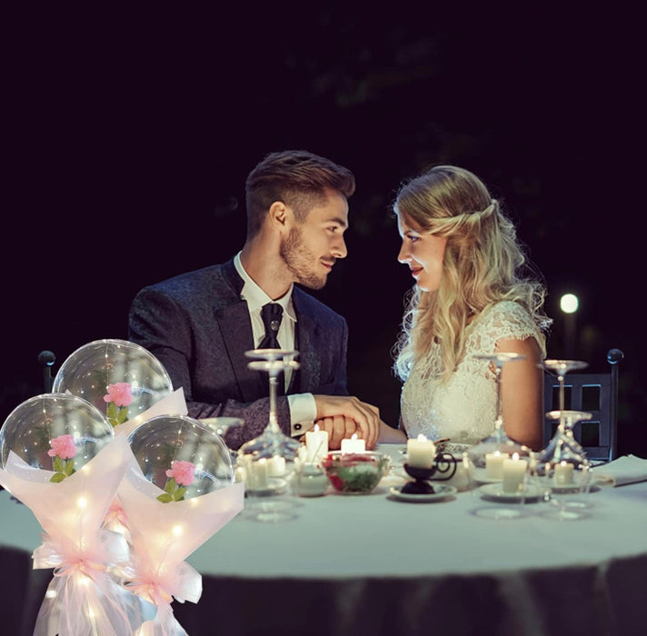 Couple sharing a romantic dinner at night with candles and flowers.