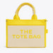Yellow and beige tote bag with 'THE TOTE BAG' text on a white background